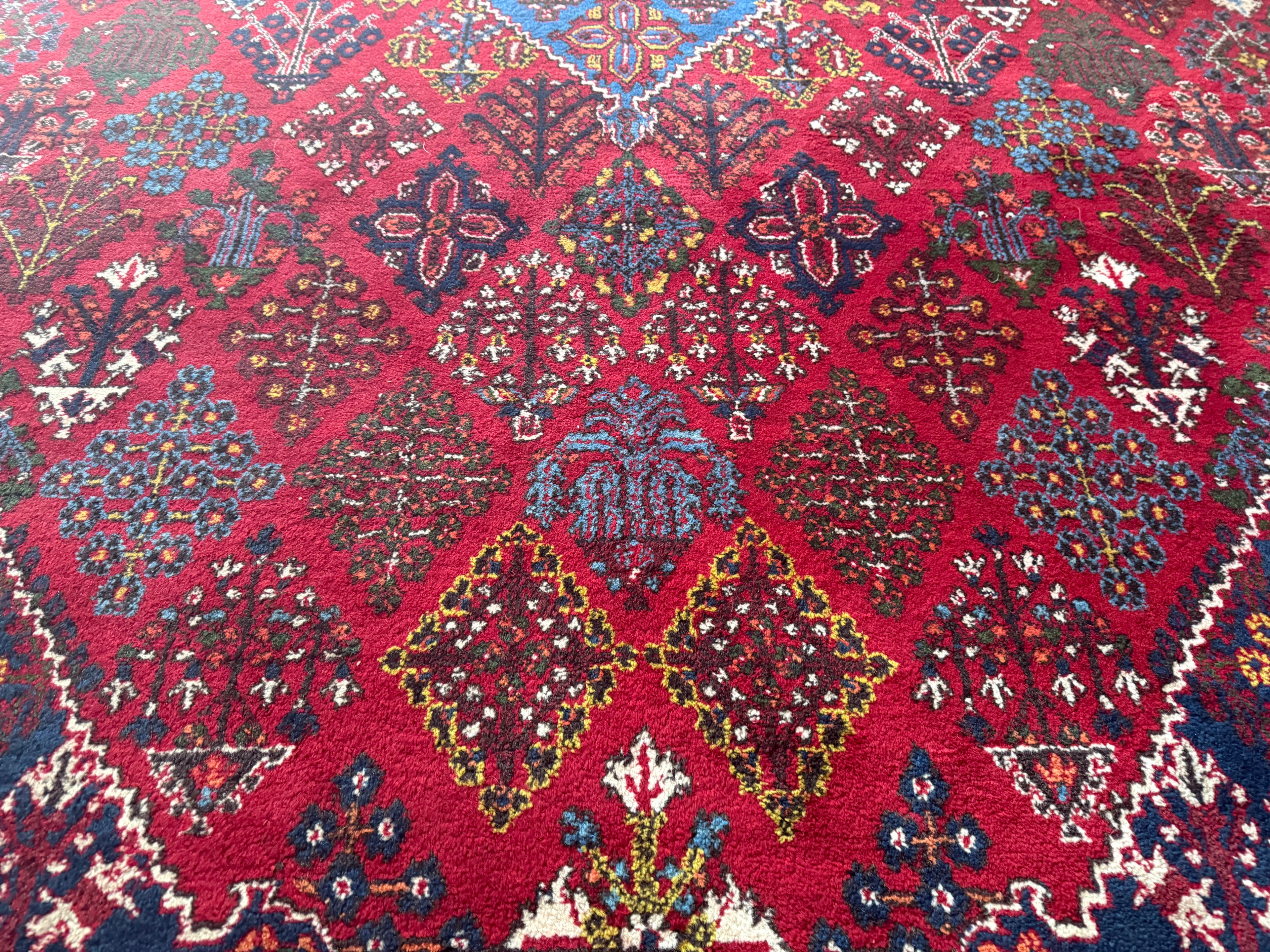 Groot vintage tribaal tapijt 355 × 241 cm – rood veld met blauw medaillon