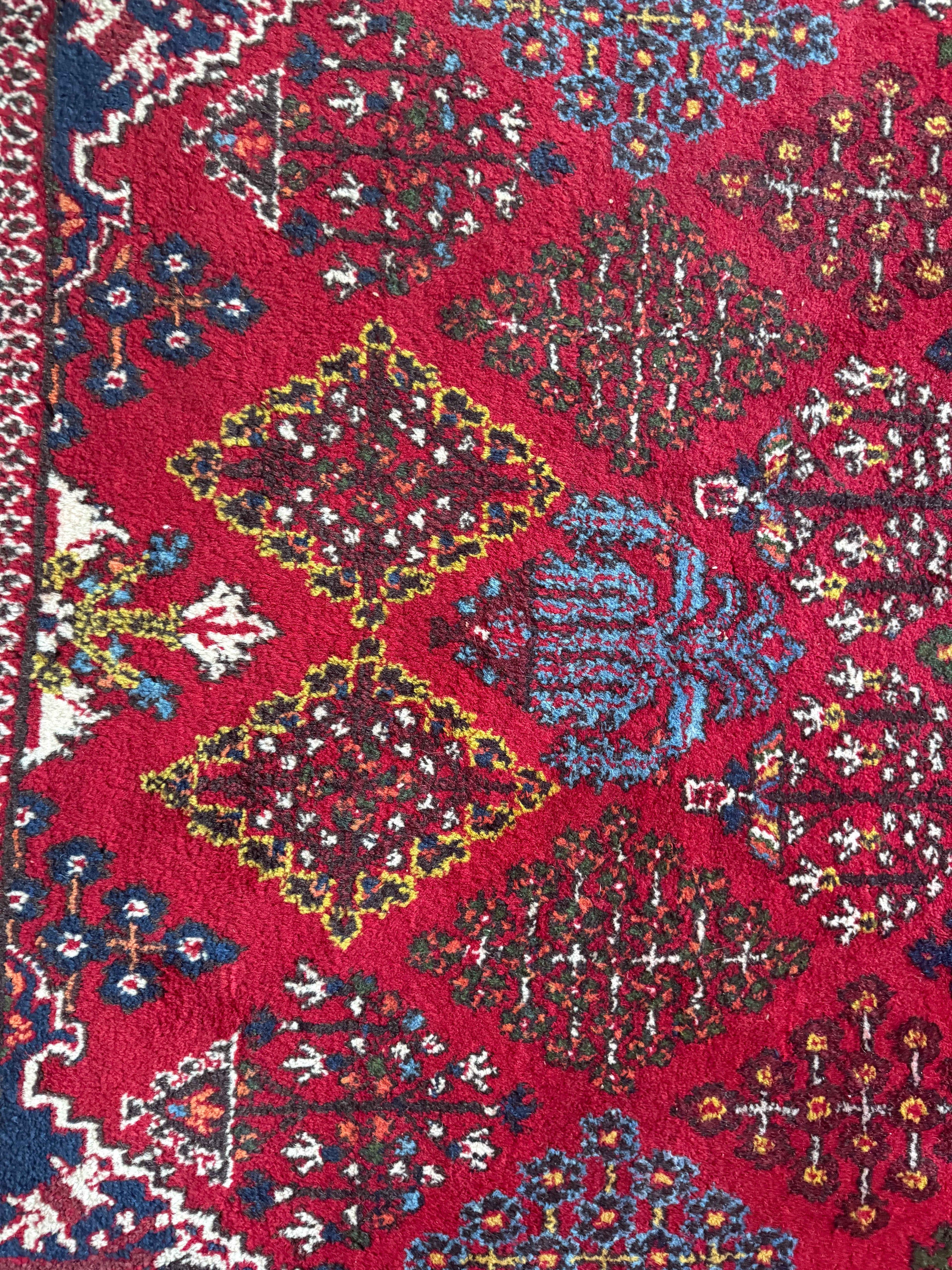 Groot vintage tribaal tapijt 355 × 241 cm – rood veld met blauw medaillon